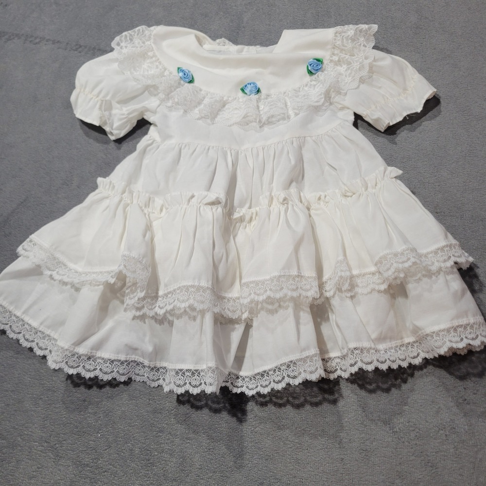White Lace Tiered Baby Girl Dress with Blue Rosette Accents